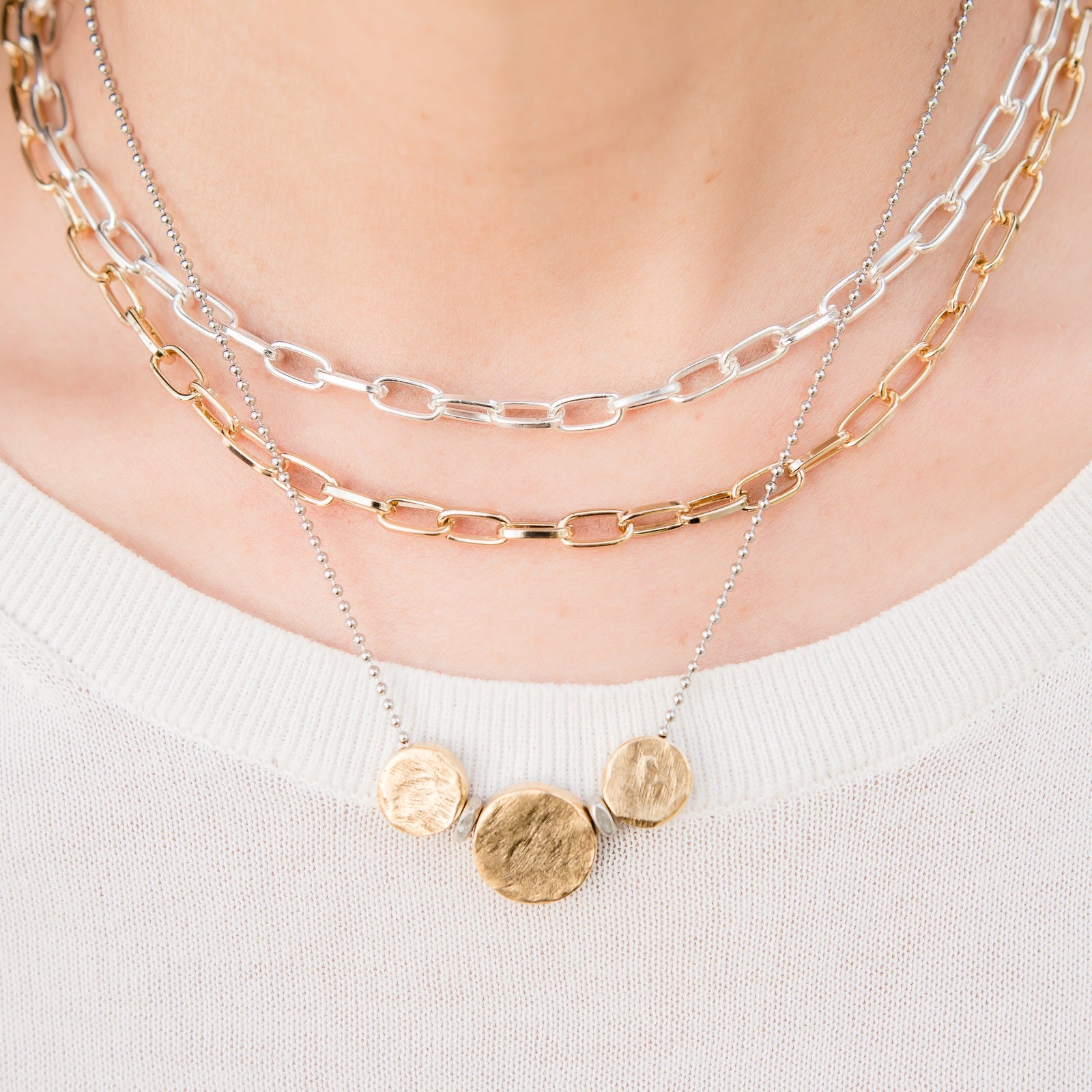 Necklace with gold pendants on a white background