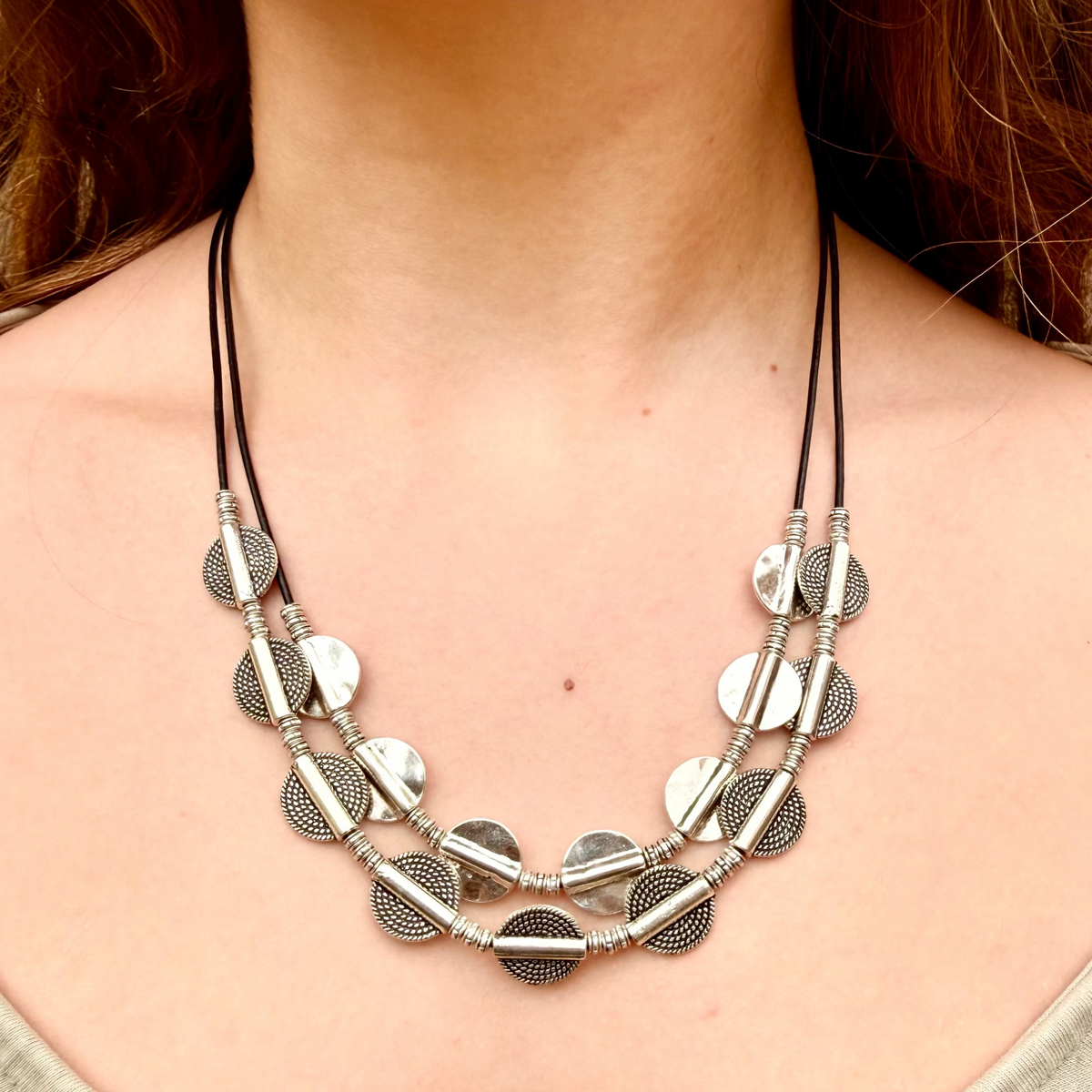 Vesper black leather 2-tier The Vesper Layers 2-tier black leather necklace with silver-plate textured disks and round beads.