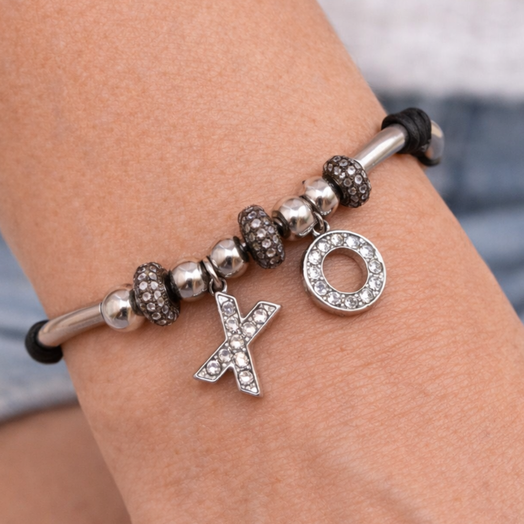 Women's black leather bracelet with silver XO charms, silver-tone beads, and pavé crystal accents.