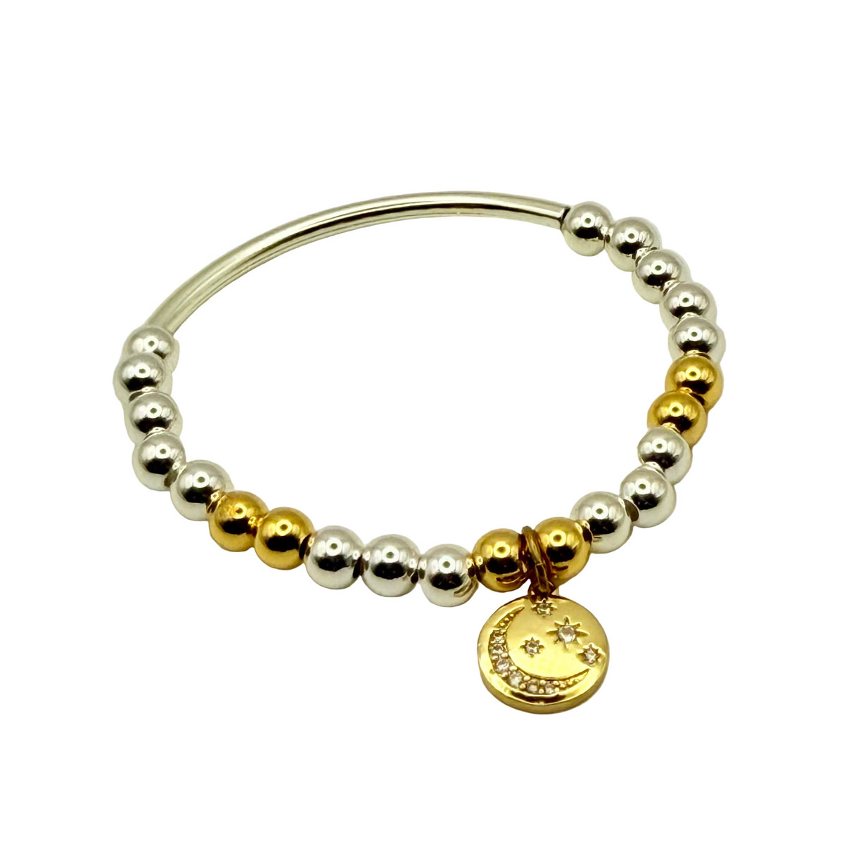 Beaded bracelet with gold and silver beads and a gold charm on a light gray background