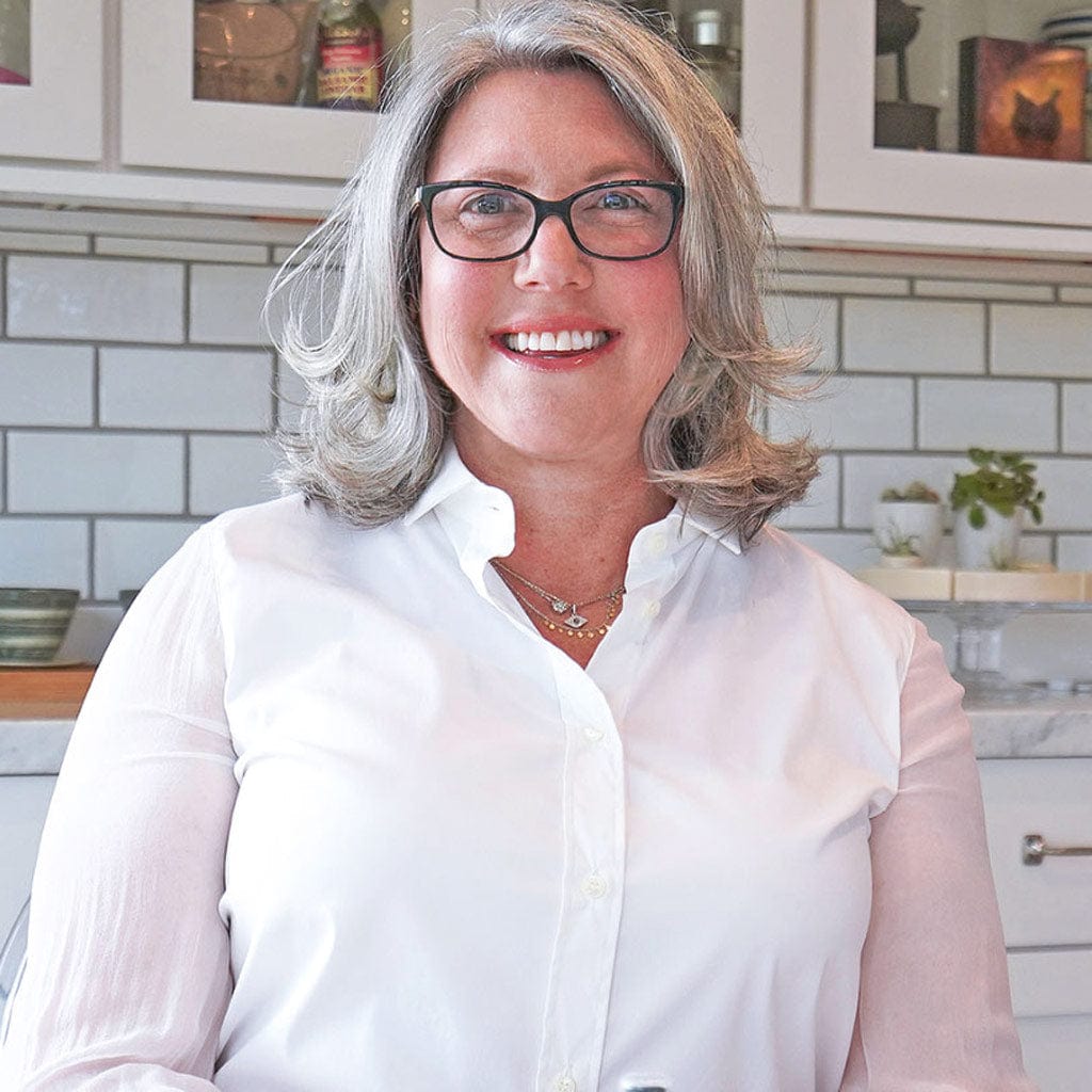 Lizzy wearing a white shirt in the kitchen