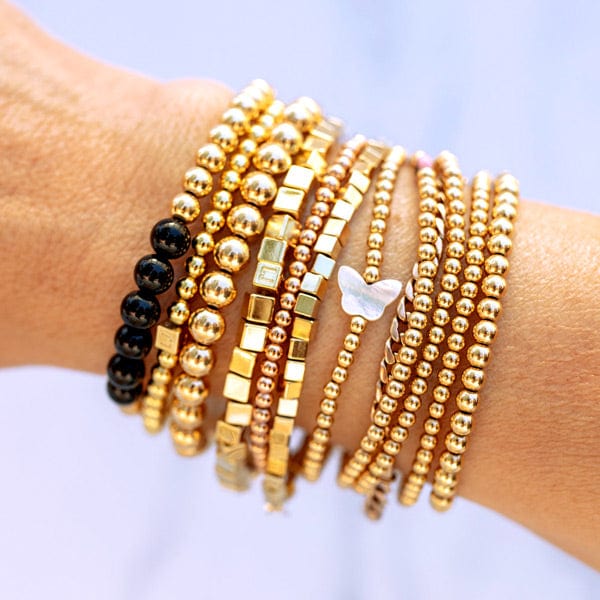 14k gold bead stretch-to-fit bracelet stacked with 3mm 14k gold-filled bracelet