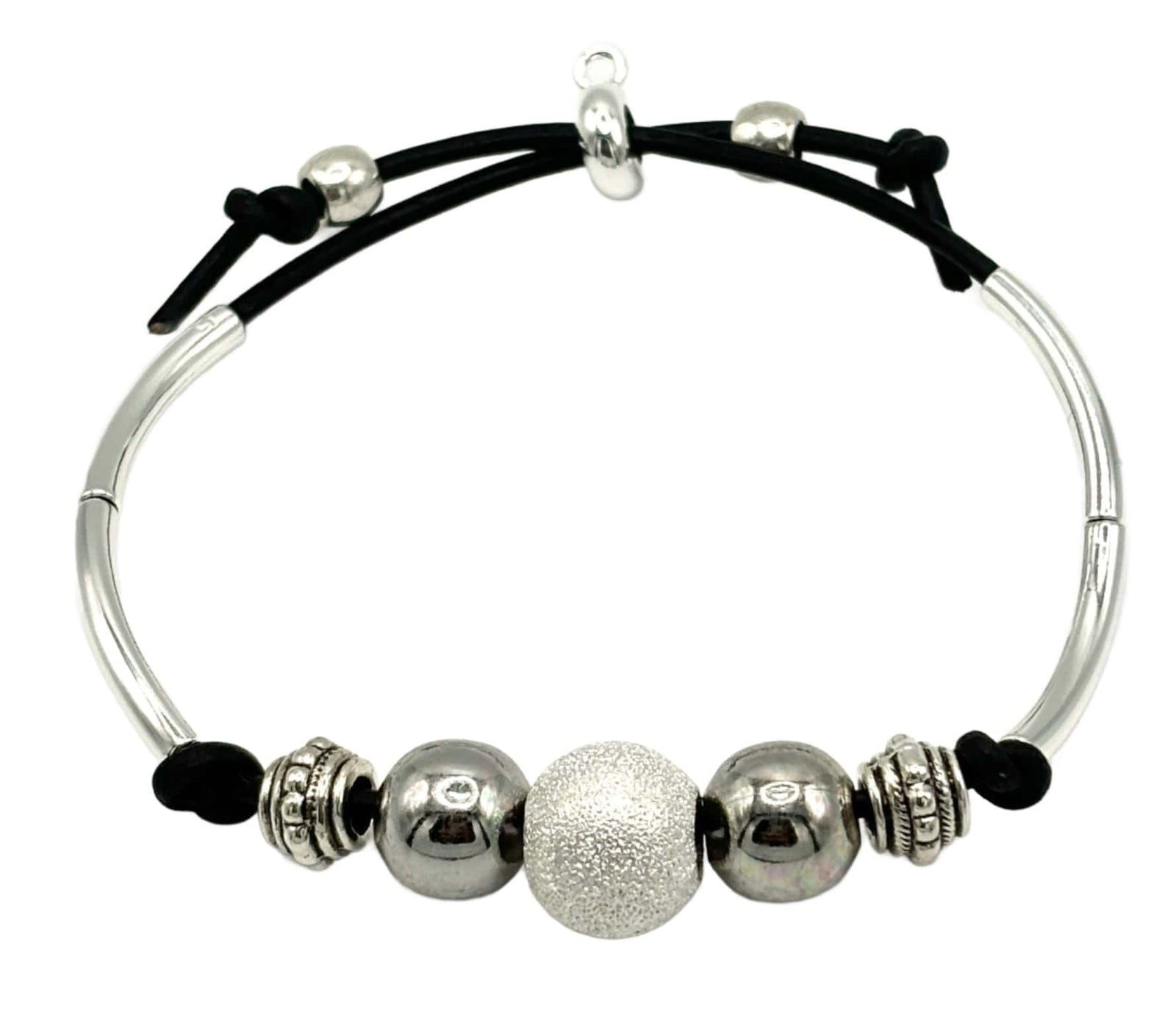 Close-up of a silver beaded bracelet on a wrist.