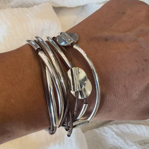 Video of leather wrap bracelet with silverplate beaded accents and crescents on write.