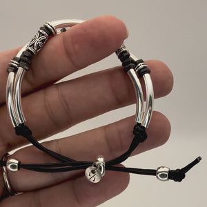 Video showing detail of the Axis Adjustable Black Leather Bracelet with Silver PLated crescents, etched silver tube beads and black hexigon beads