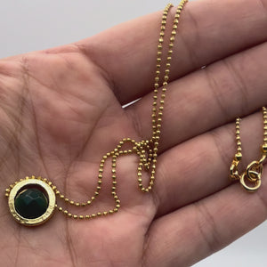 Video of the Celine Emerald Green Jade Necklace held in a hand showing the detail.