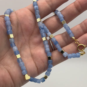 Aquamarine 16 inch necklace with gold heart focal and faceted gemstone cubes video demonstrating detail and clasp.