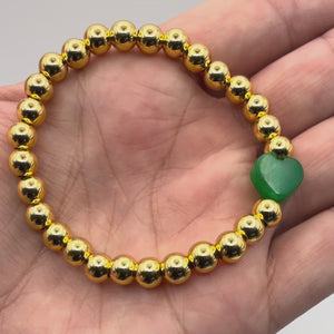 Video of the Everly Emerald Jade Bracelet held in a hand showing the detail.