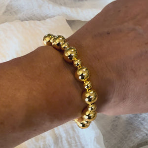 Gold bracelet on wrist.