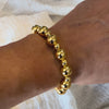 Gold bracelet on wrist.