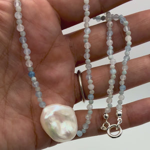 Close-up video of Aquamarine and baroque pearl necklace showing faceted 2mm and 3mm beads shimmering beside gold accents