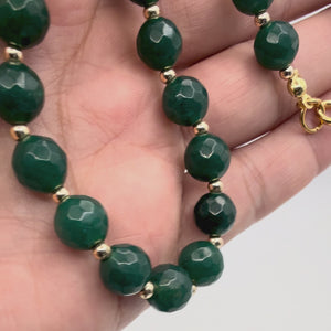 Video of the Arden Jade Necklace with large Emerald Green Faceted & small Gold beads held in a hand showing detail. 