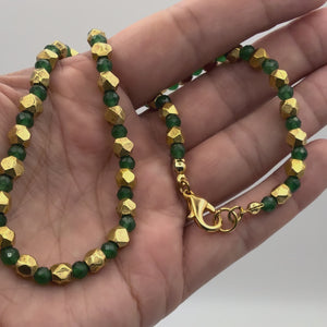 Video of the Isla Emerald Jade Necklace with Vintage Gold & Green Jade Beads held in a woman's hand showing the detail.