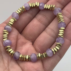 Shop The Lilac Mist Bracelet. Features 8mm faceted lavender amethyst rondelles with elegant satin-finish gold square accents. A waterproof, easy-on stretch-to-fit bracelet handmade in the USA. Perfect for everyday elegance.