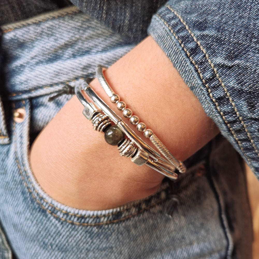 Sofi Adjustable Black Leather Bracelet with Silver Plated Crescents &amp; Gold Obsidian Focal shown next to the Lim Sterling silver bracelet