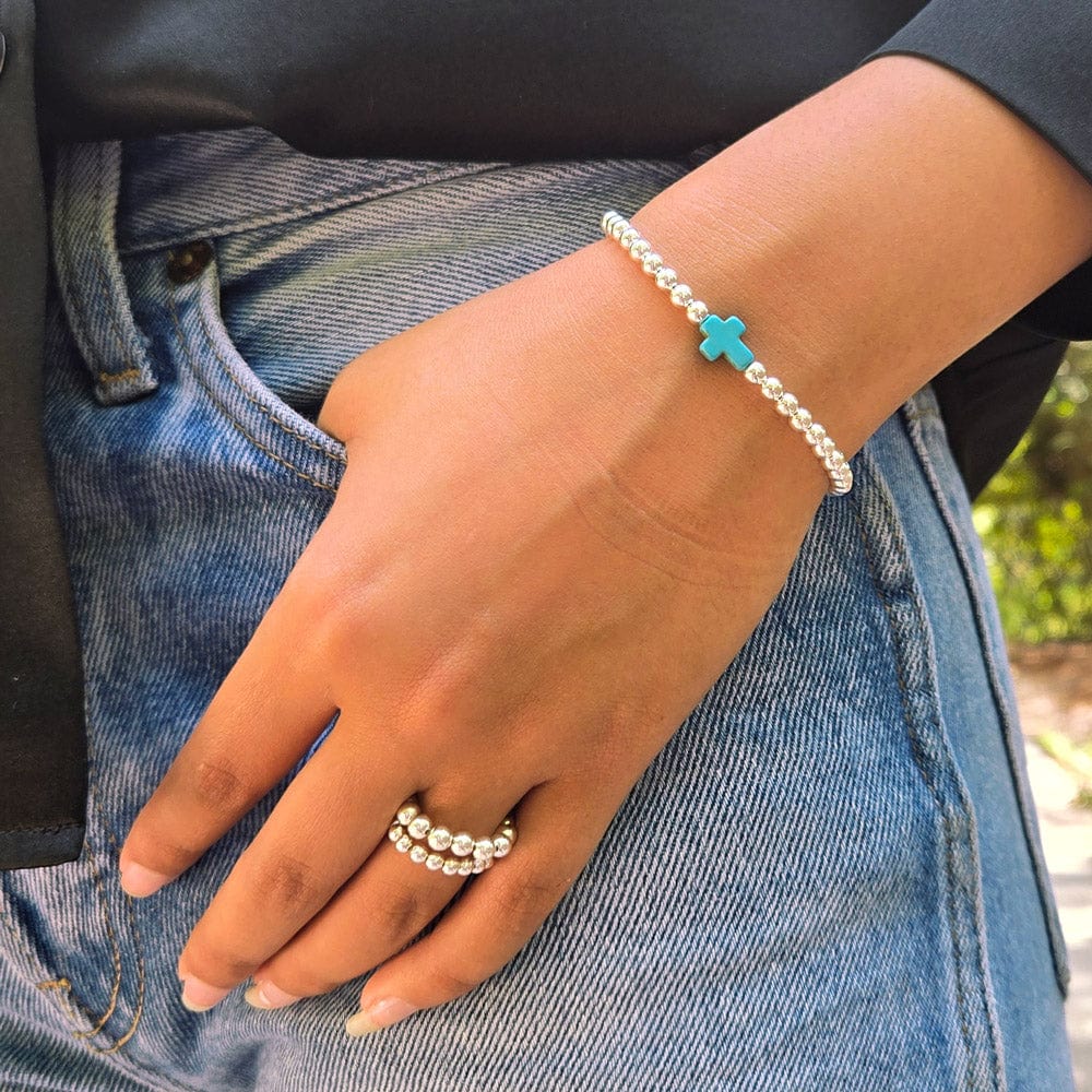 Sterling Silver Stretch Bracelet with Turquoise Cross Charm and Two Bead Rings