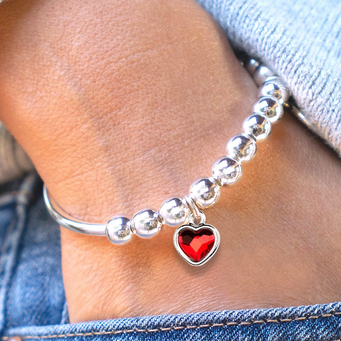 Lori adjustable silver bracelet with red crystal charm